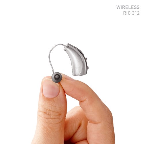 33 Halo IQ RIC 312 Sterling Silver Hearing Instrument being held in a caucasian mans hand